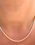 Diamond Tennis Necklace | 5.87 CTW Lab-Created or Natural Diamonds on a models neckline - Camille Jewelry