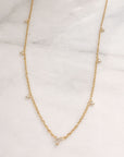 layering diamond necklace styling on marble display - Camille Jewelry