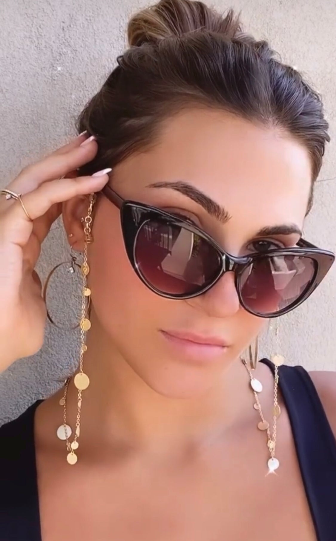 Gold plated disc charm convertible necklace worn on. model with sunglasses by Camille Jewelry.