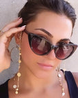 Gold plated disc charm convertible necklace worn on. model with sunglasses by Camille Jewelry.