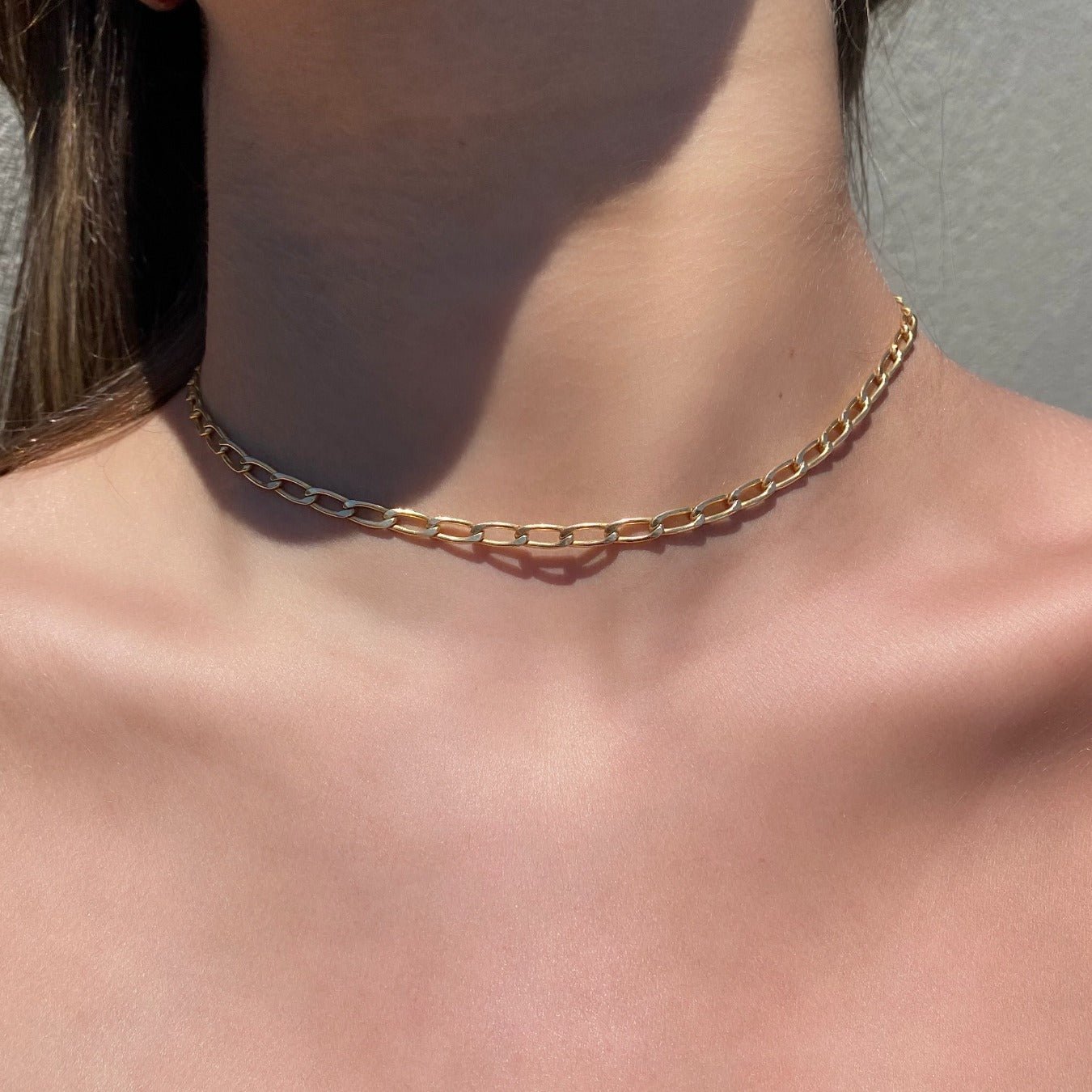Gold Filled Medium Elongated Curb Chain Necklace on models neckline by Camille Jewelry