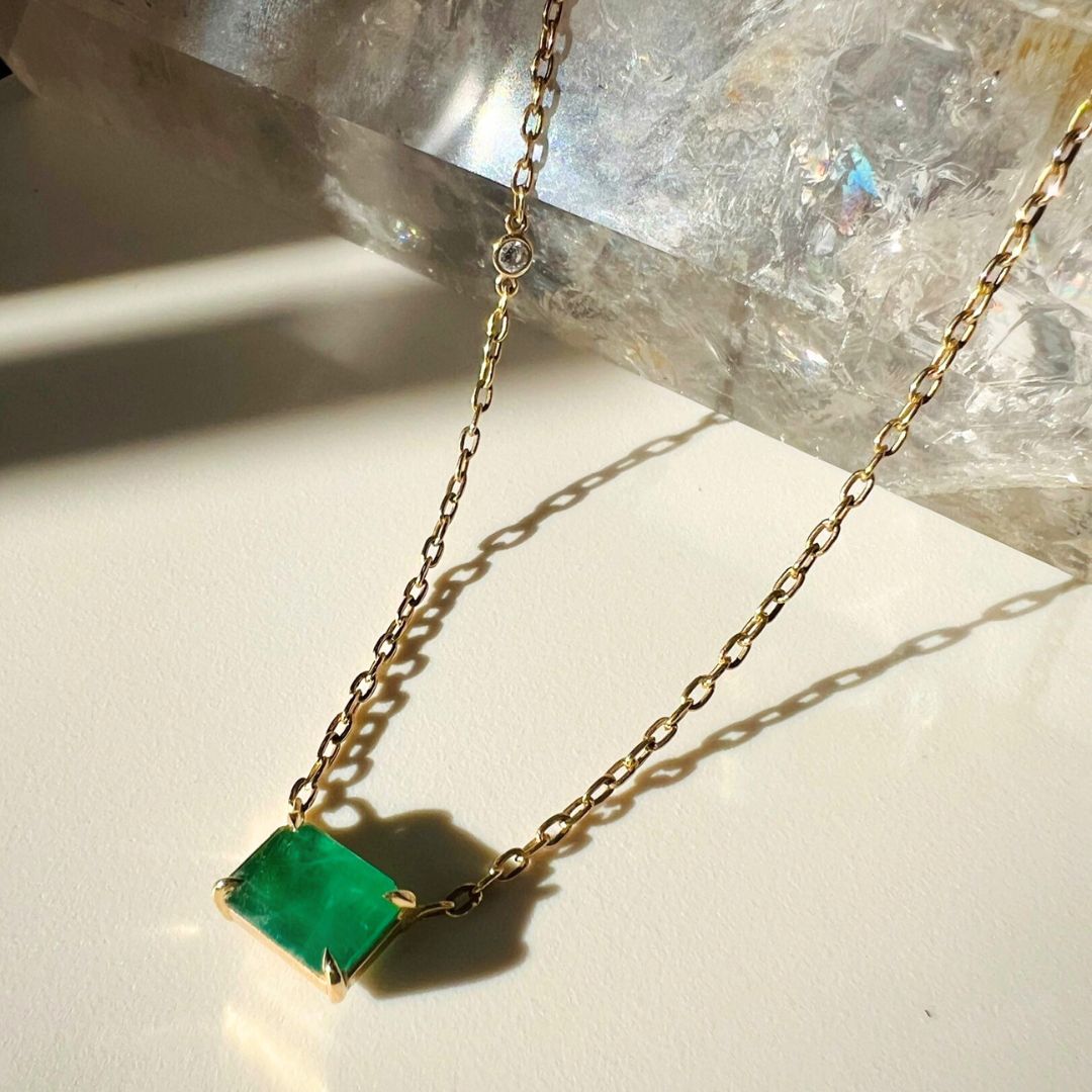 14k yellow gold Emerald Necklace With Diamond Accent on display by Camille Jewelry