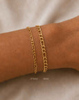 Woman wearing a figaro chain bracelet 2.5mm & 4.5mm in 14K gold filled with a toggle closure by Camille Jewelry