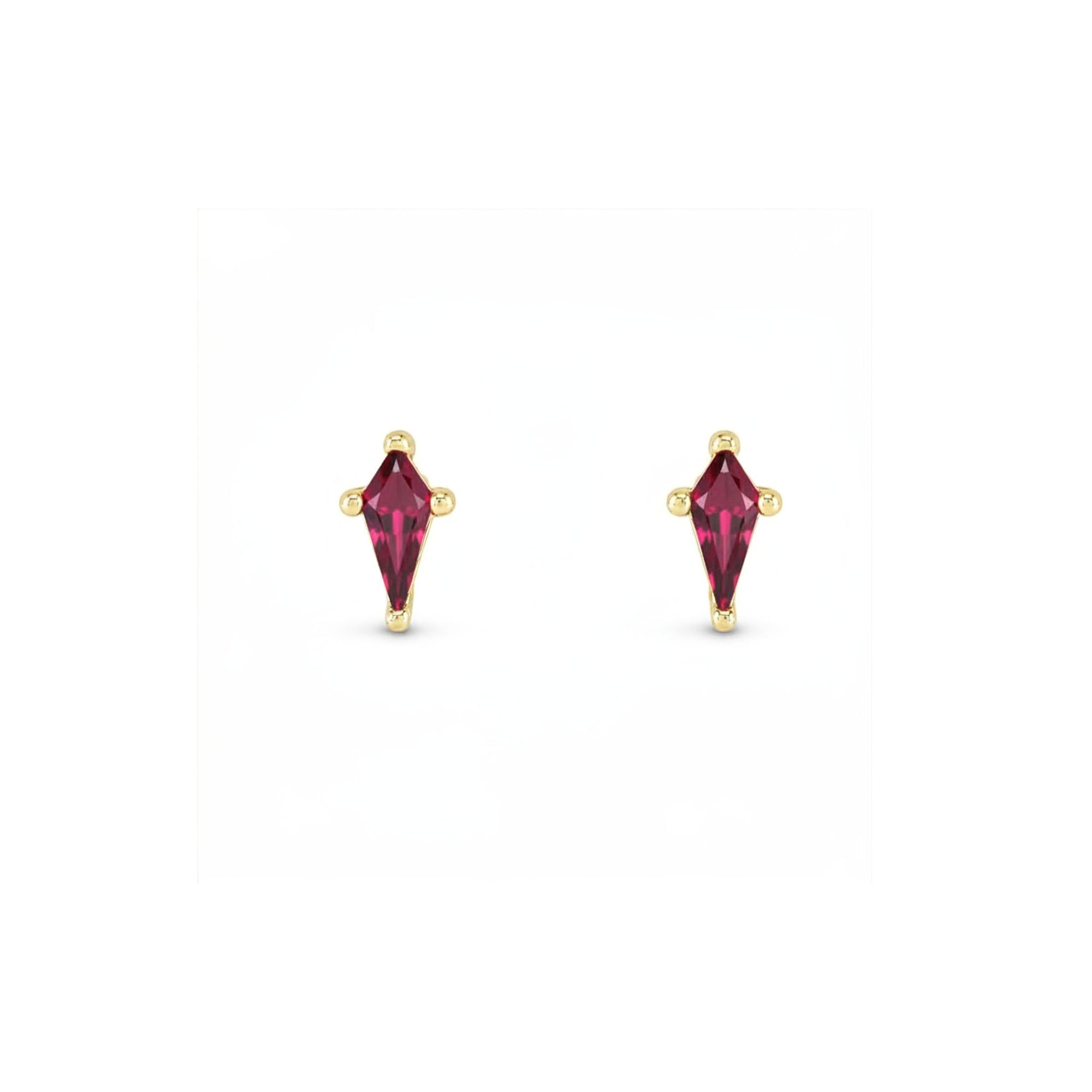 Kite cut lab created emerald stud ruby in 14K yellow gold on a white background by Camille Jewelry