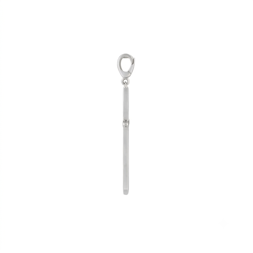 Side profile of a gold cross charm in 14K yellow gold showing the clip bail and knife edge depth by Camille Jewelry