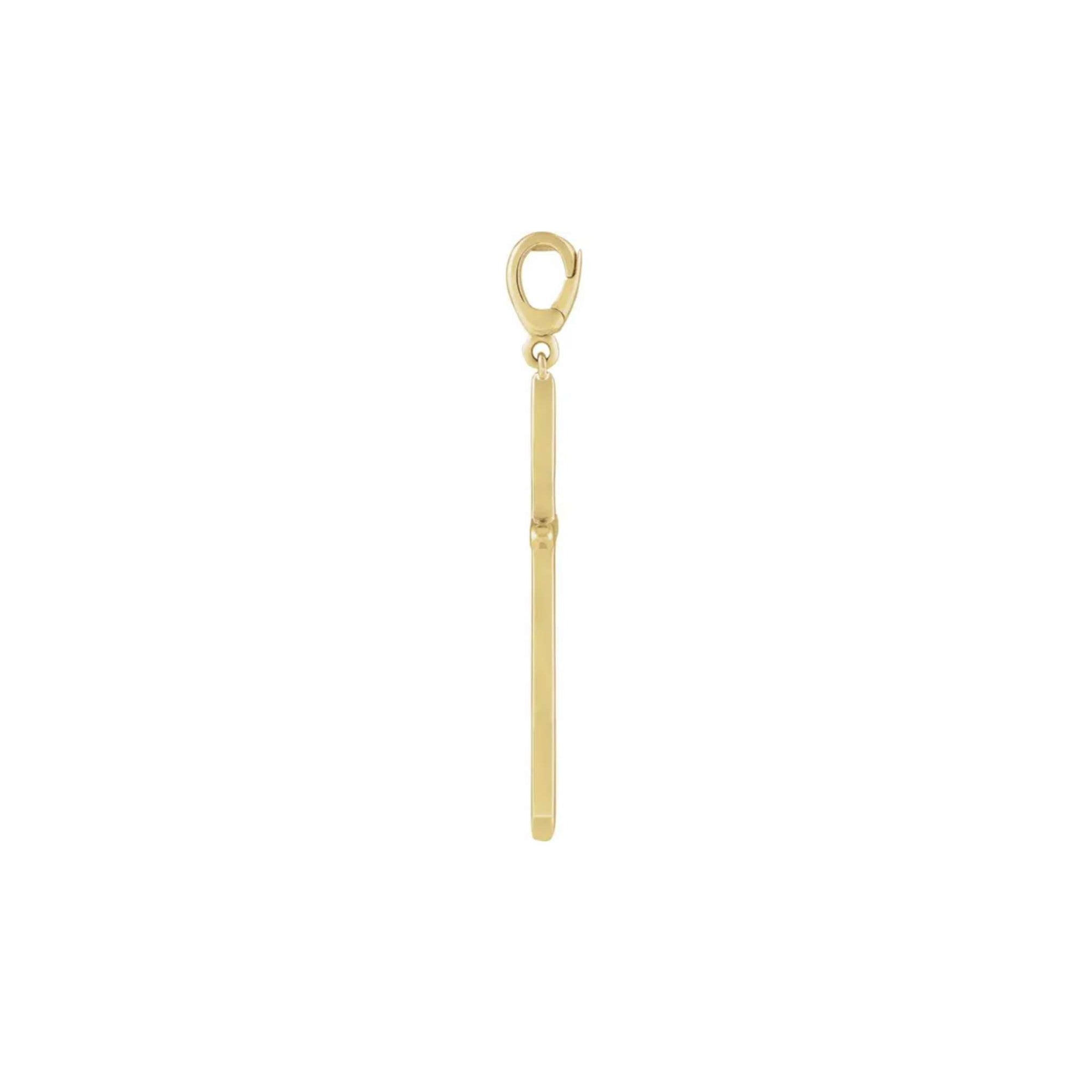 Side profile of a gold cross charm in 14K yellow gold showing the clip bail and knife edge depth by Camille Jewelry