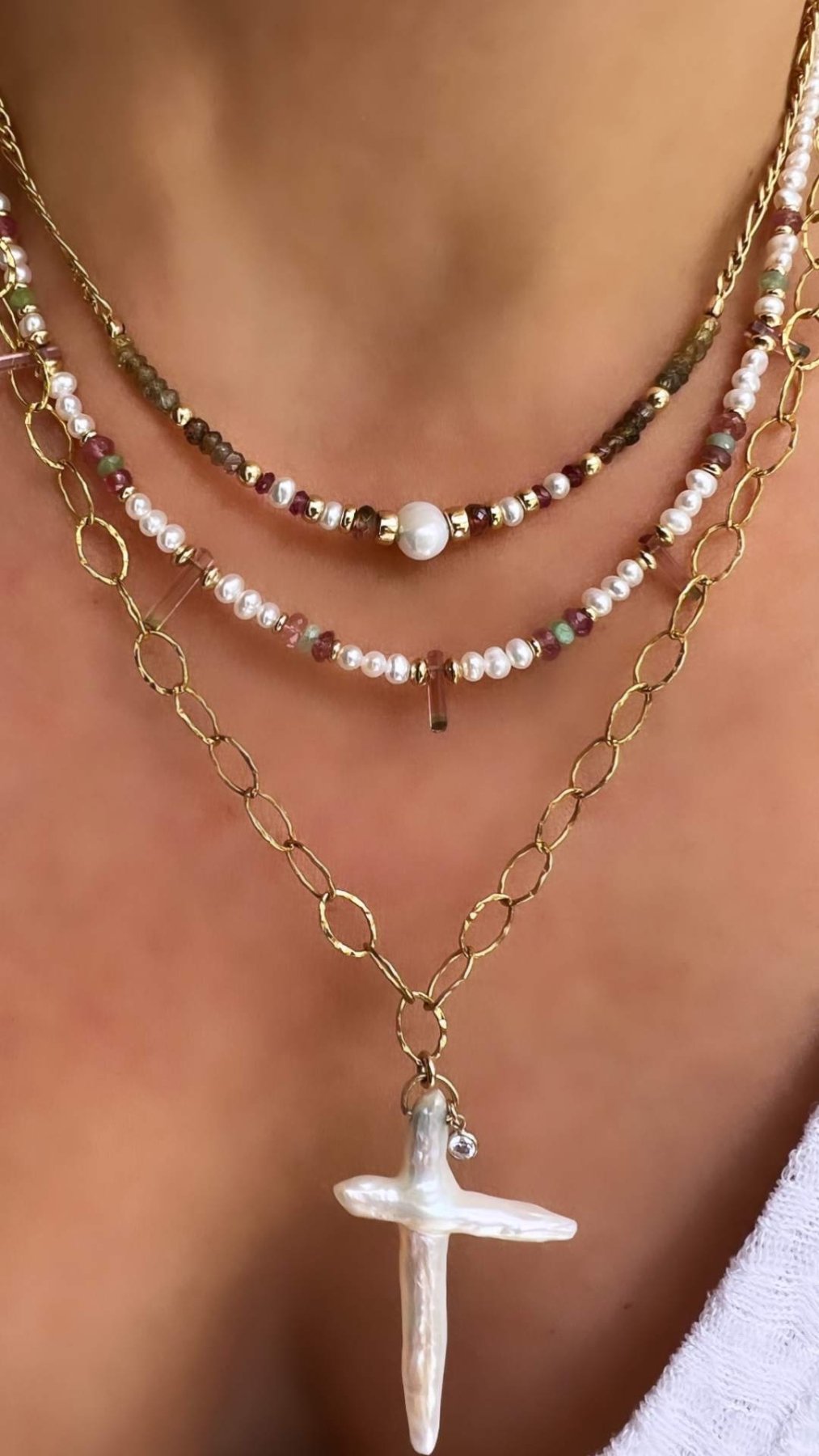 Woman wearing a gold filled beaded necklace with freshwater pearls and gemstones by Camille Jewelry
