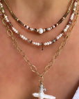 Woman wearing a gold filled beaded necklace with freshwater pearls and gemstones by Camille Jewelry