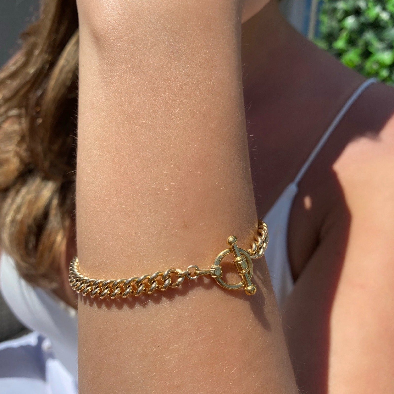Gold Filled Curb Chain Toggle Bar Bracelet on models arm by Camille Jewelry