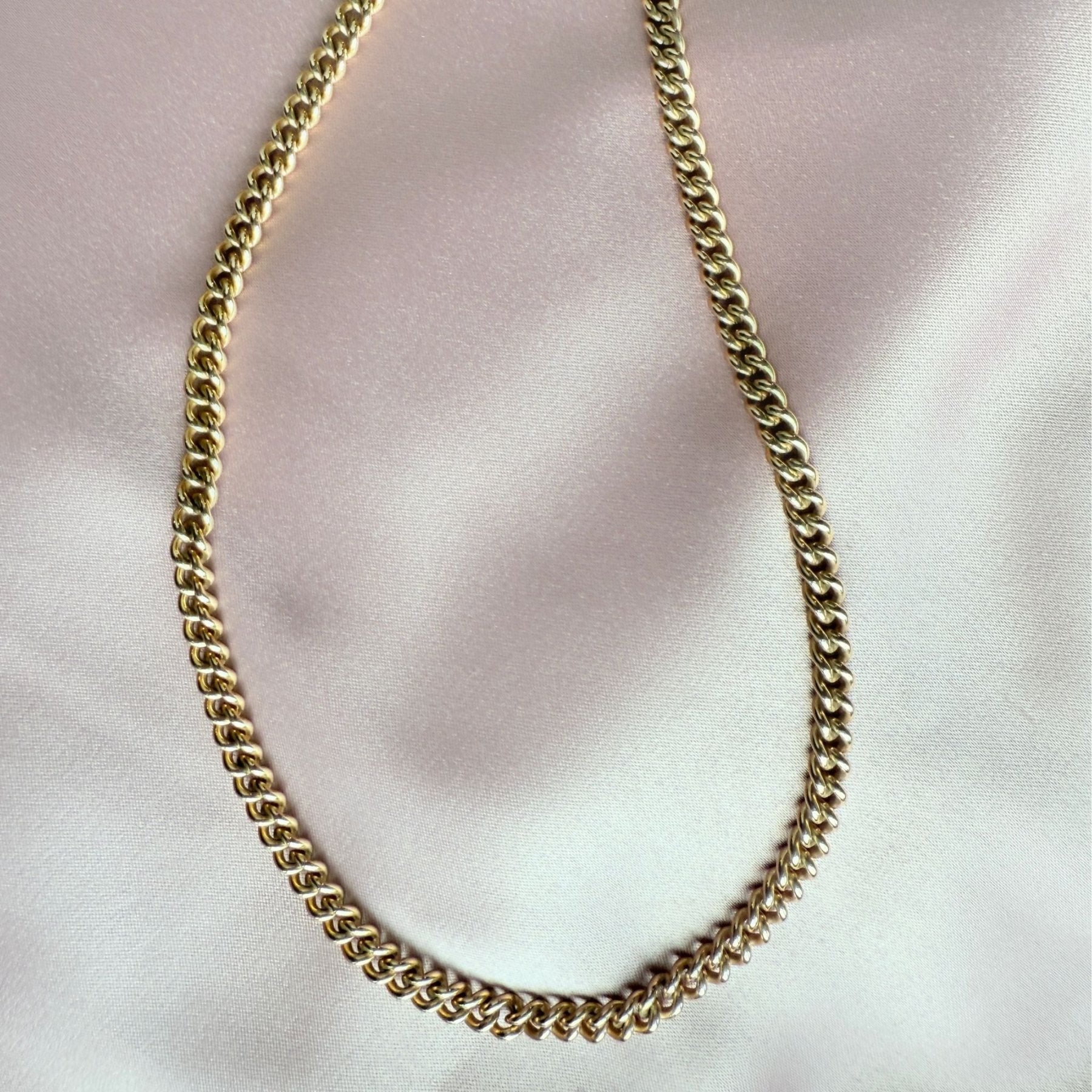  gold filled curb chain link necklace in 14K gold filled on soft pink cloth by Camille Jewelry