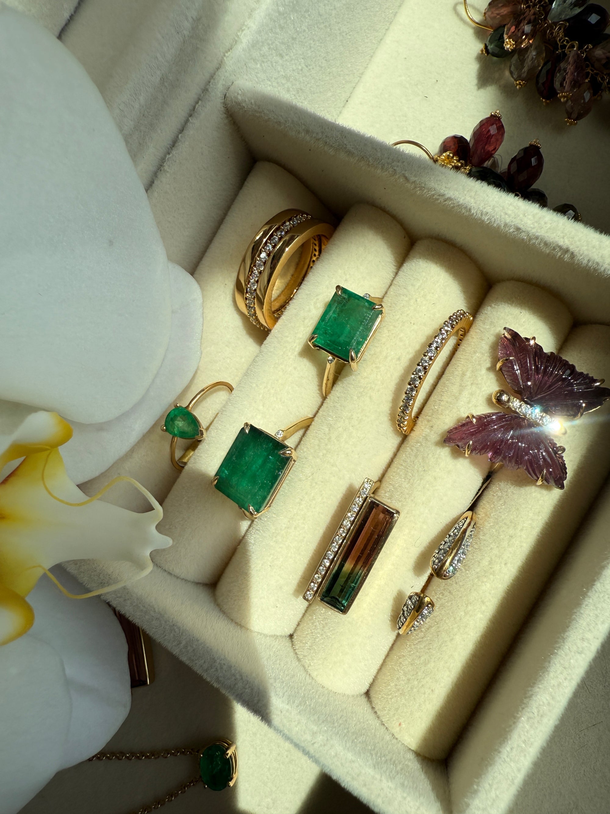 Precious Jewelry in diamonds, emeralds, tourmaline and gemstones on a jewelry case by Camille Jewelry.