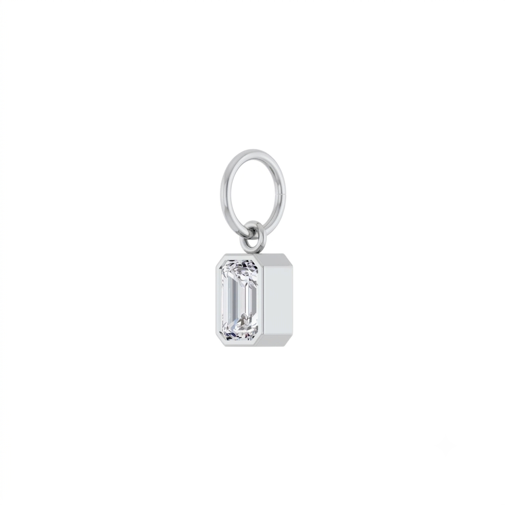 Lab grown diamond charm in 14K yellow gold with a bezel set stone on a white background angled view by Camille Jewelry