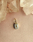 Close up of a bezel set lab grown diamond charm in 14K yellow gold showing the 5/8 carat stone by Camille Jewelry
