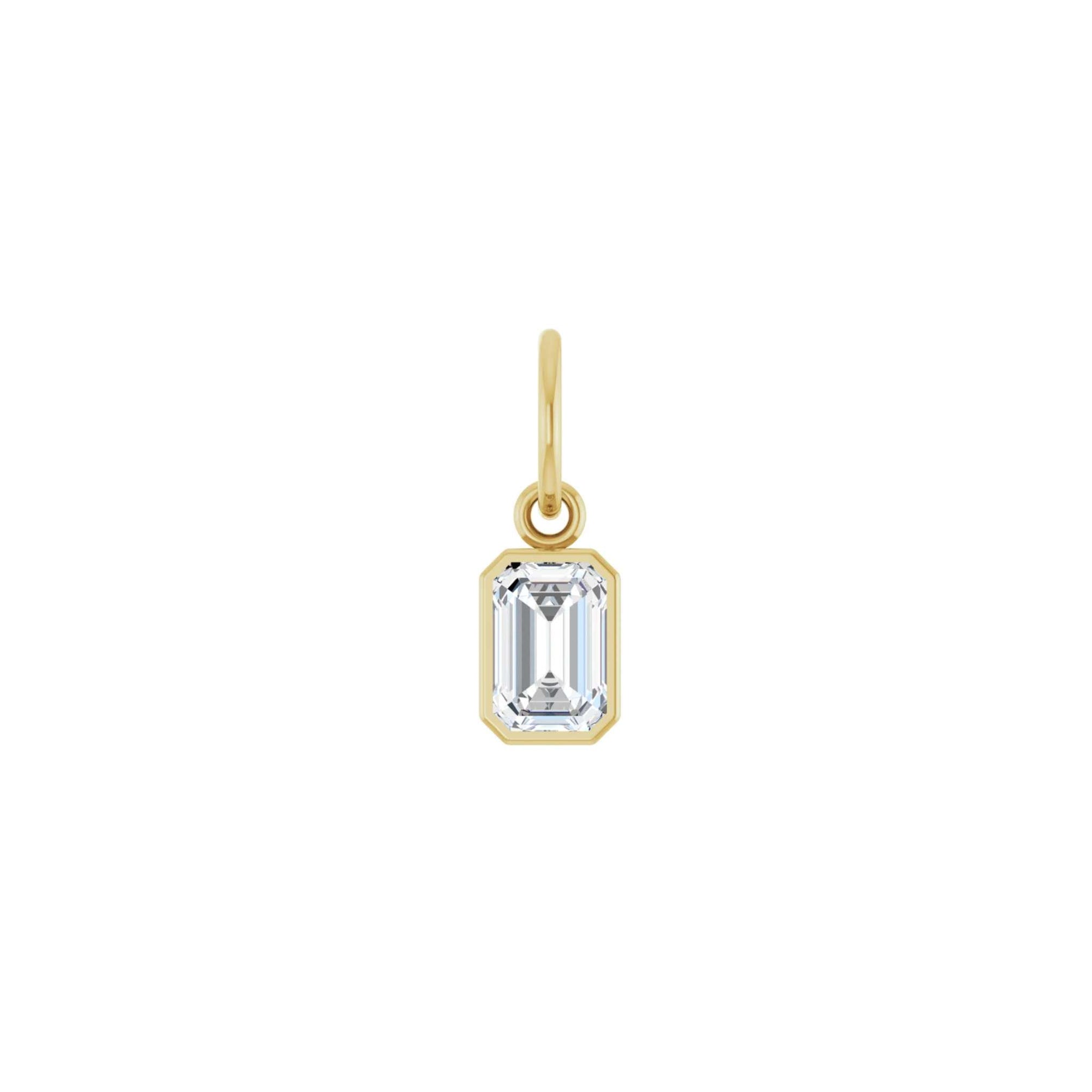 Lab grown diamond charm in 14K yellow gold with a bezel set stone on a white background by Camille Jewelry