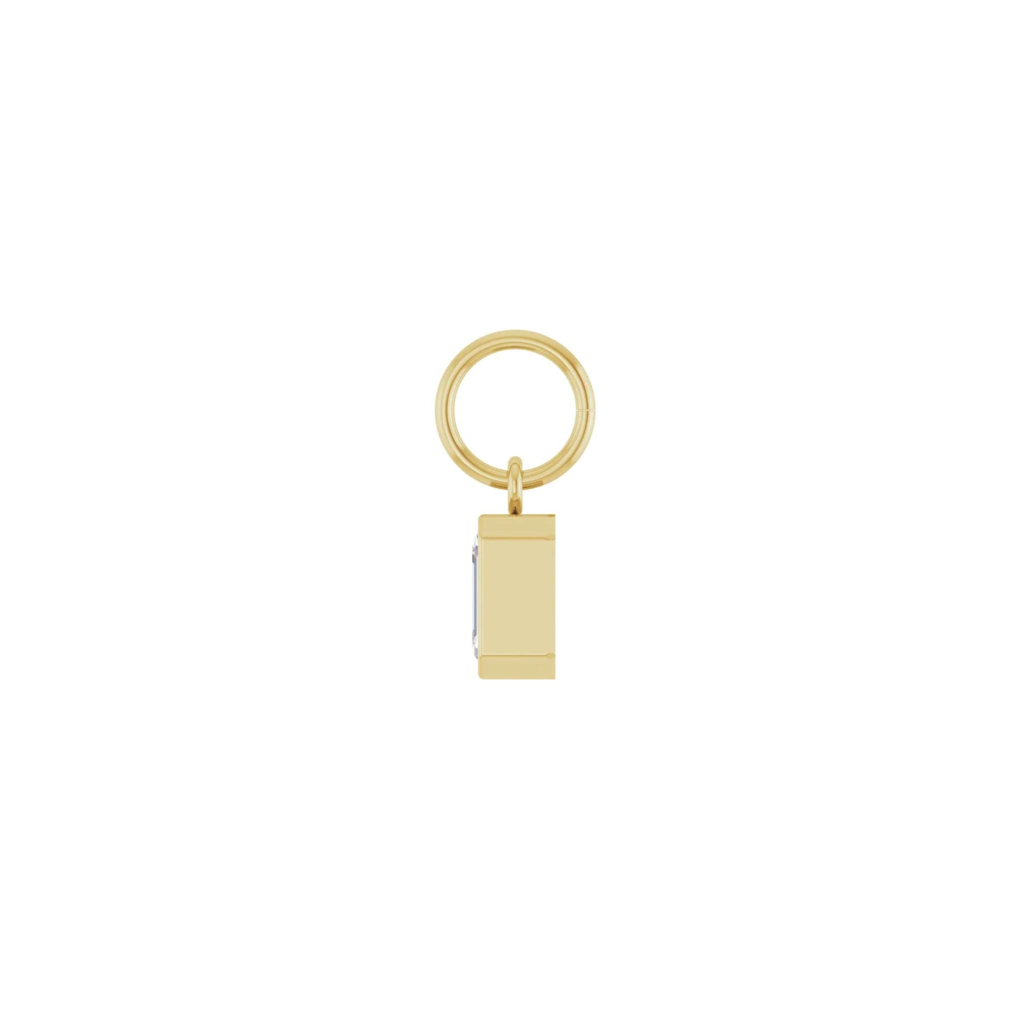 Lab grown diamond charm in 14K yellow gold with a bezel set stone on a white background side view by Camille Jewelry