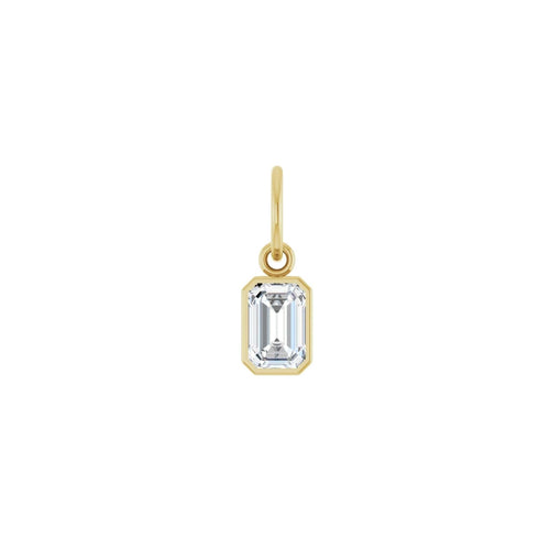 Lab grown diamond charm in 14K yellow gold with a bezel set stone on a white background by Camille Jewelry