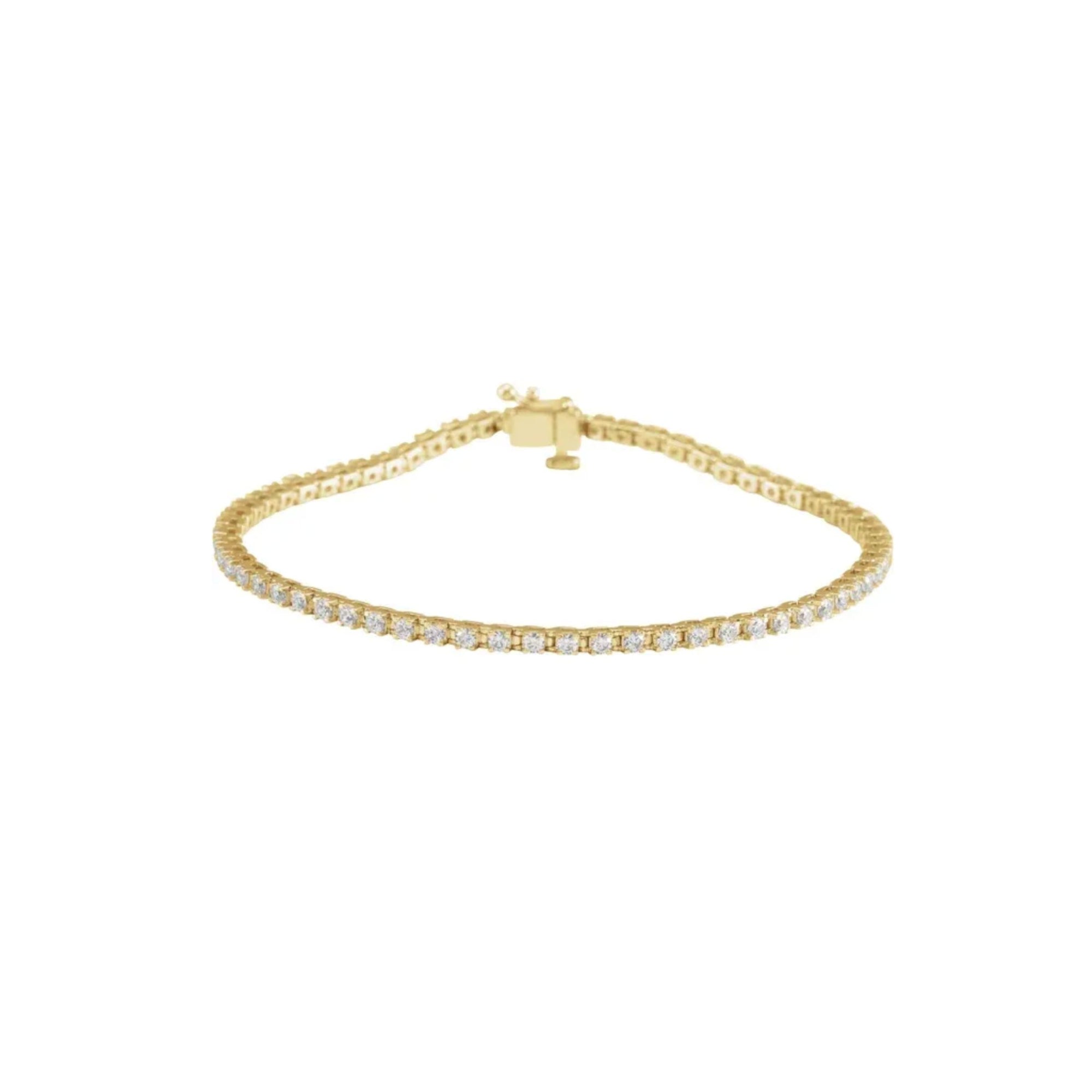 Lab grown diamond tennis bracelet in 14K yellow gold on a white background by Camille Jewelry