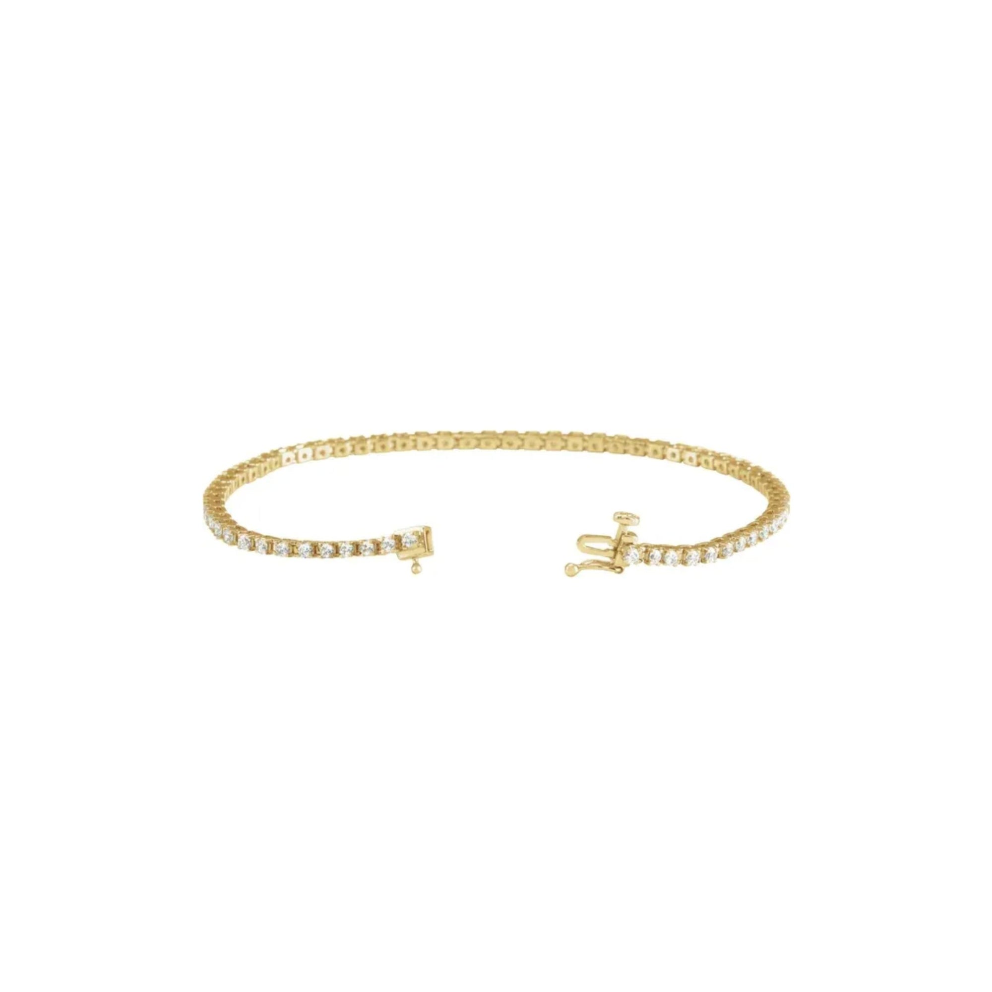 Open clasp detail of a lab grown diamond tennis bracelet in 14K yellow gold on a white background by Camille Jewelry