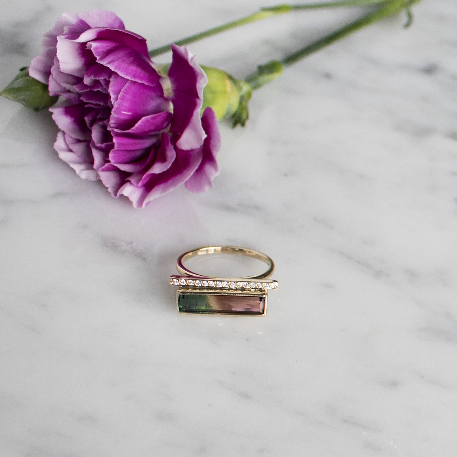 14K yellow gold Diamond Bar Tourmaline Gemstone Ring with flower in background on stone - Camille Jewelry