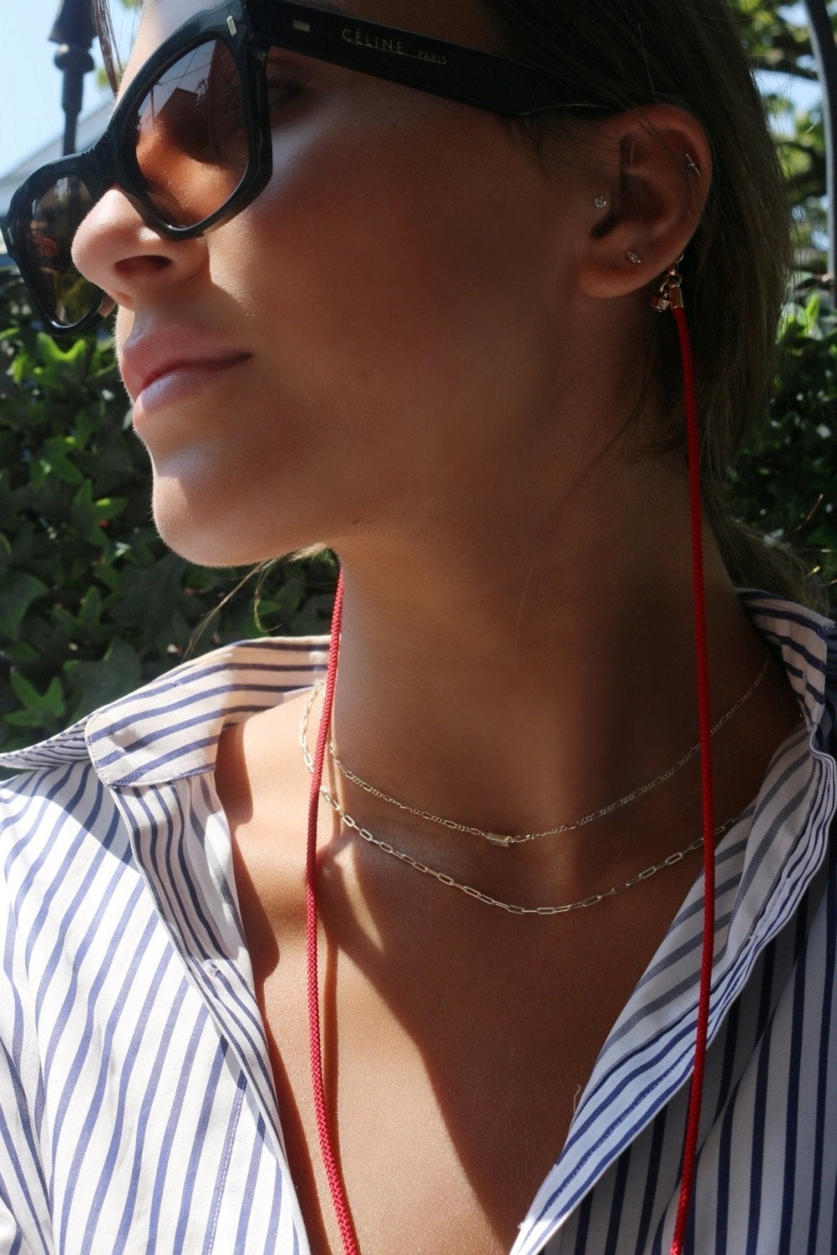 Red Magnetic Cord Strap Necklace For Eyewear Women's, Men's, Kids on a model with glasses- Camille Jewelry