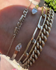 14K yellow gold petite script Mama Bracelet with other chain styles on model- Camille Jewelry