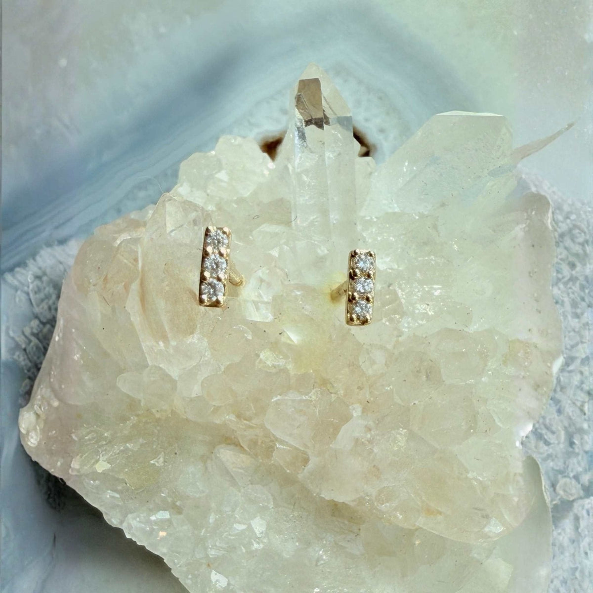 Mini Diamond Bar Stud Earrings on a quartz display by Camille Jewelry