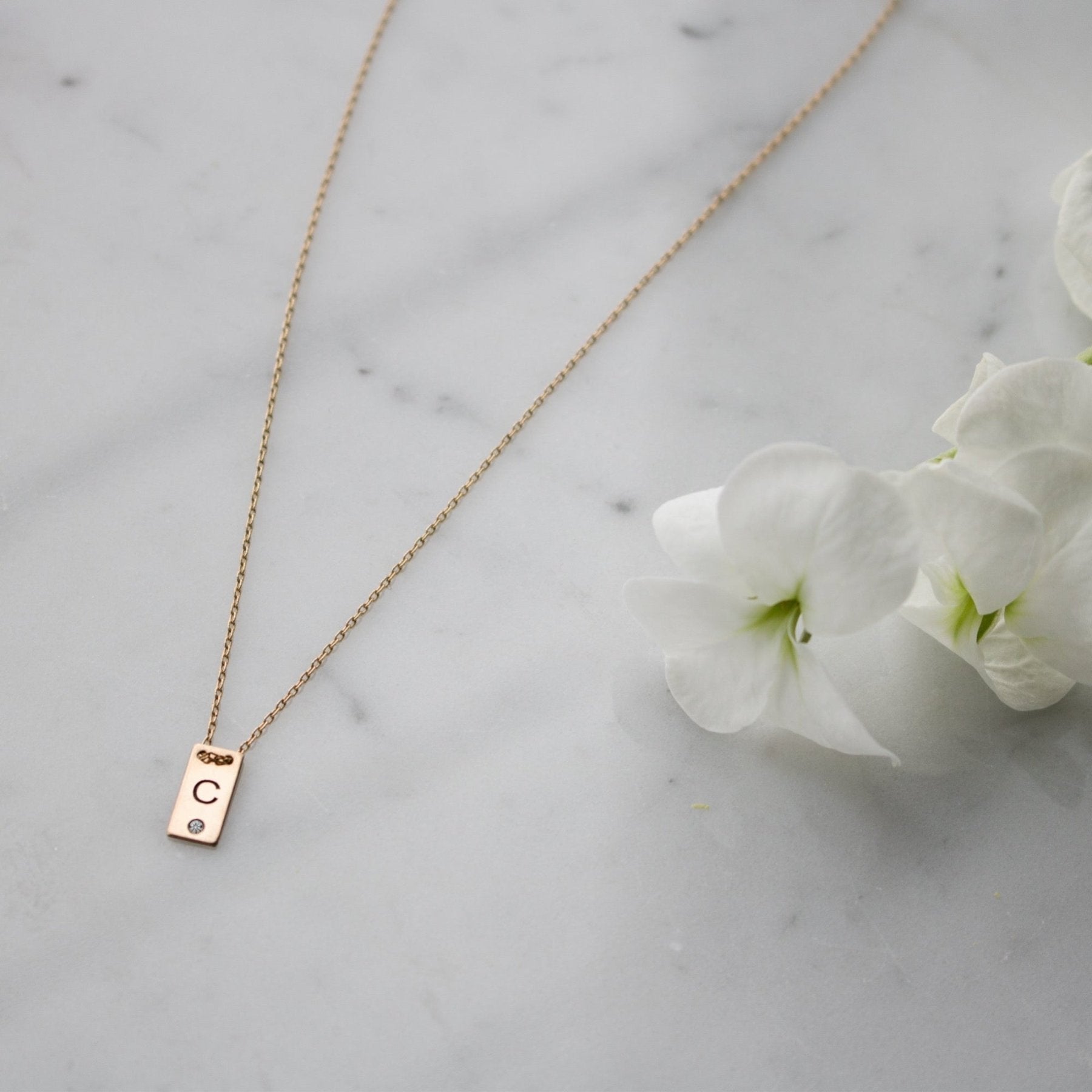 14K gold filled Mini Plaque Personalized Necklace on a quartz background- Camille Jewelry