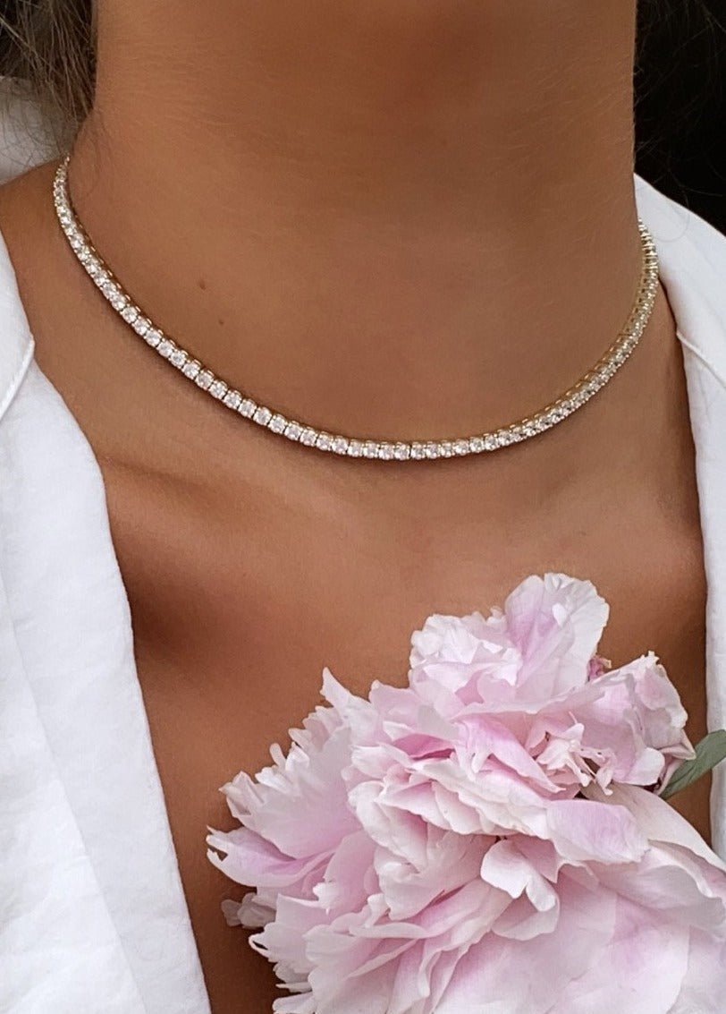 Woman wearing a modern tennis necklace in gold plated sterling silver by Camille Jewelry