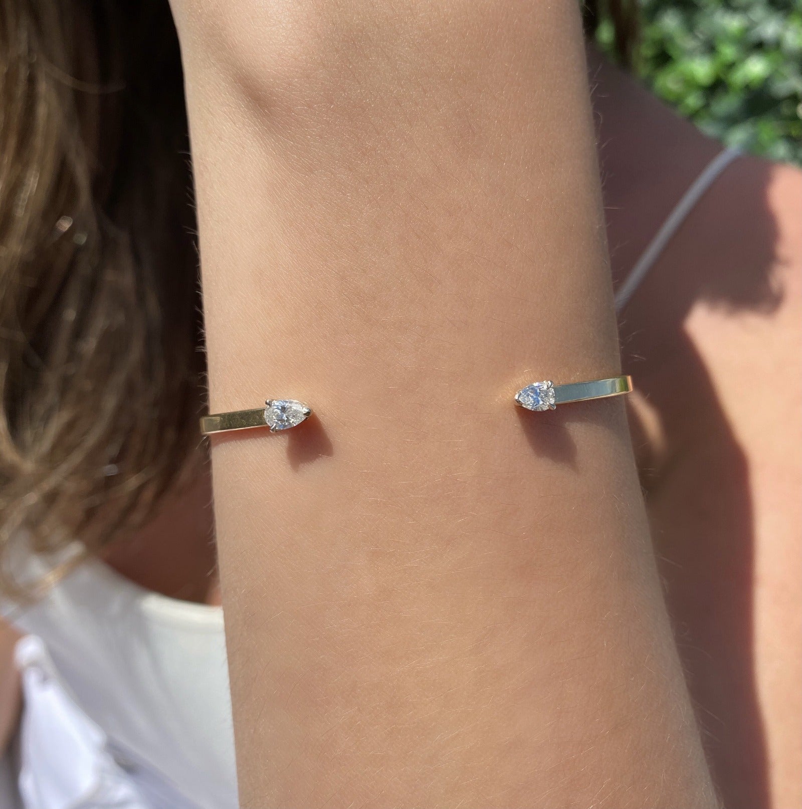 Open Cuff Bracelet | Pear-Shaped Diamond Bangle in 14K Yellow Gold on white background- Camille Jewelry