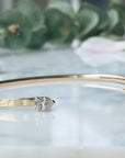 Open Cuff Bracelet | Pear-Shaped Diamond Bangle in 14K Yellow Gold on quartz display- Camille Jewelry