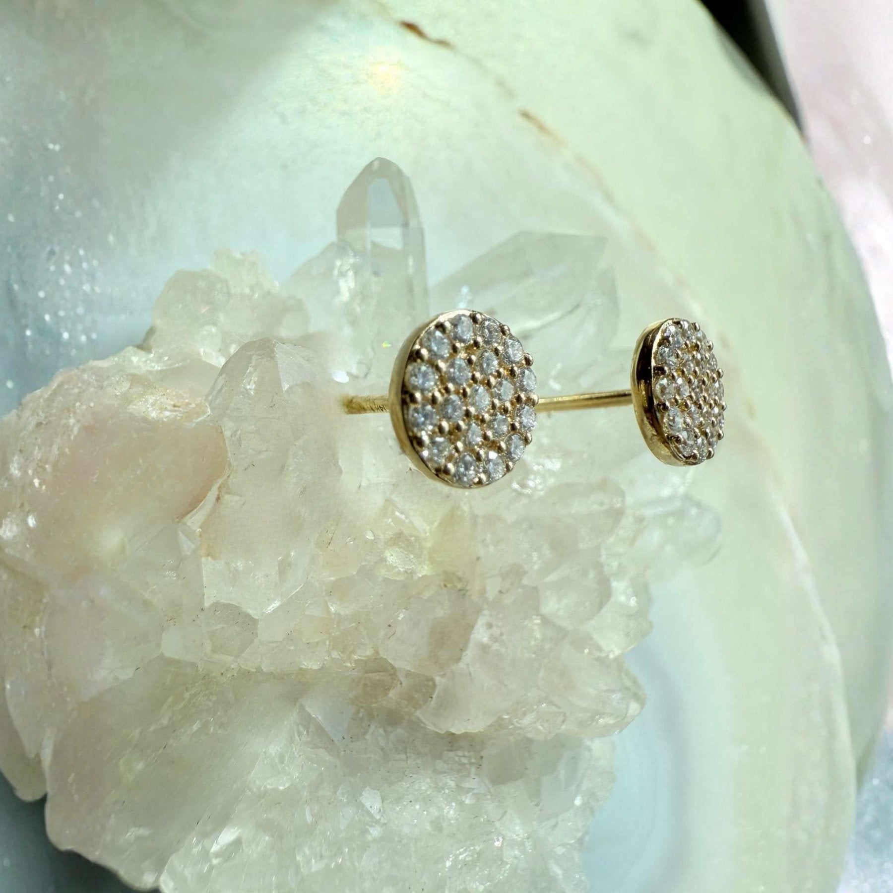 Pavé Diamond Stud Earrings in 14K yellow gold on a quartz stone display by Camille Jewelry