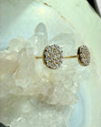 Pavé Diamond Stud Earrings in 14K yellow gold on a quartz stone display by Camille Jewelry