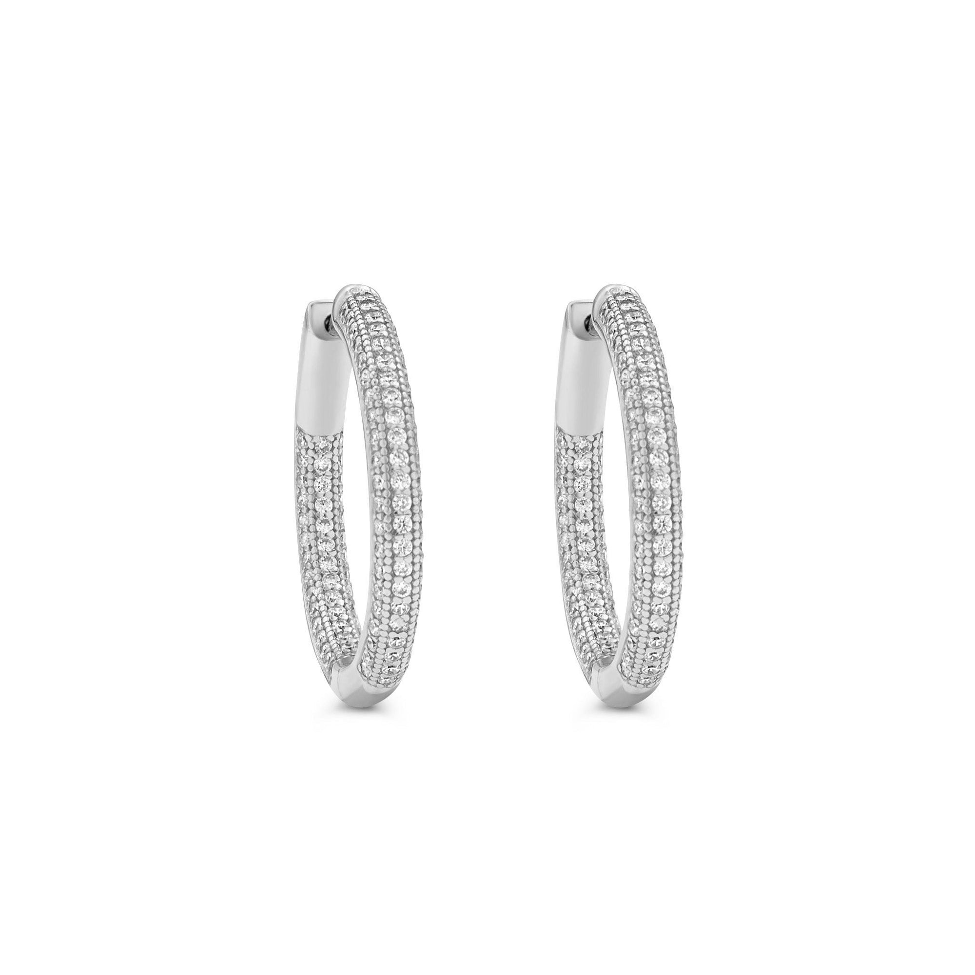 Pavé hinged hoop earrings in 14K gold plated sterling silver with cubic zirconia on a white background by Camille Jewelry