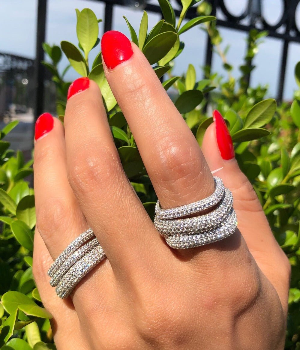 Woman wearing a pavé square ring in 14K gold plated sterling silver stacked with other rings by Camille Jewelry

