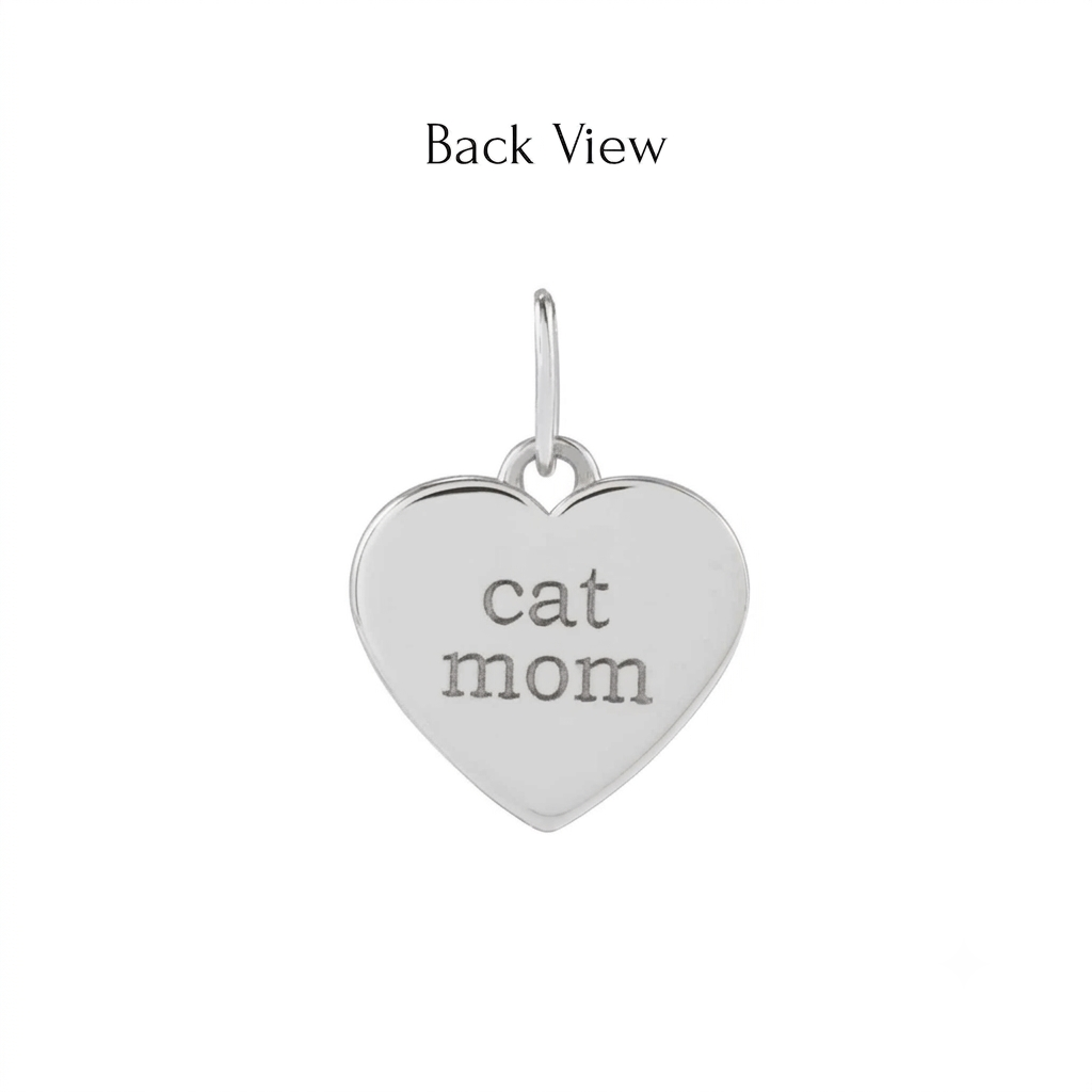 Back view of a heart shaped paw print charm in 14K yellow gold engraved with cat mom by Camille Jewelry