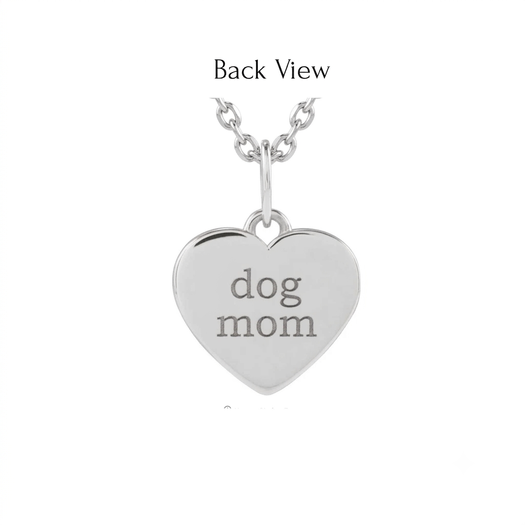 Back view of a heart shaped paw print charm in 14K yellow gold engraved with dog mom by Camille Jewelry