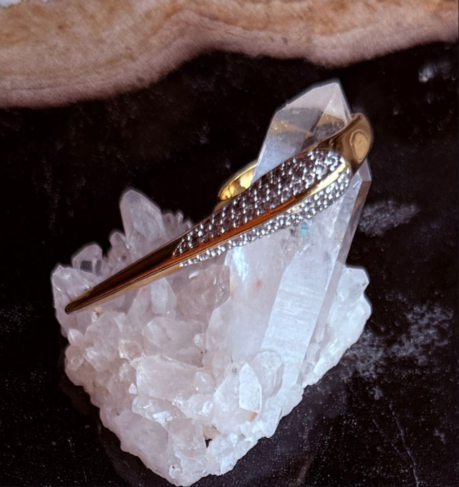 Camille Jewelry Phoenix Collection crossover ring on a crystal with dark background