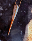 Phoenix bird beak necklace in gold on a black display with Camille Jewelry logo overlay. 