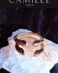 Phoenix Ring in black spinel Gold-Plated Statement Jewelry on a white Quartz display- Camille Jewelry