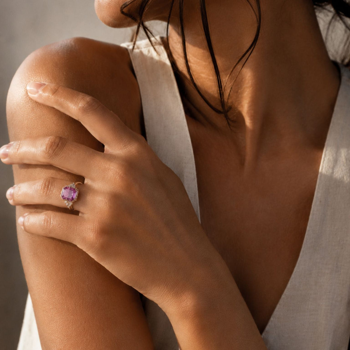 Pink Sapphire Ring in 14K Rose Gold on models hand in natural sunlight- Camille Jewelry