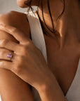 Pink sapphire ring in 14K rose gold on models hand by Camille Jewelry. 