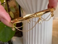 Thyra gold hinged bangle bracelet with trillion charms and chain swag | Camille  Jewelry