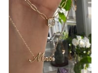 mrs. nameplate 14k yellow gold necklace and other gold chain on models hand with plants in background | Camille Jewelry