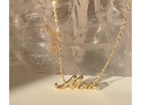 Mrs. nameplate 14k yellow gold necklace with diamond accent rotating on a quartz stone as a video | Camille Jewelry
