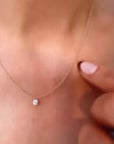 model wearing floating drilled diamond on a cable chain necklace | Camille Jewelry