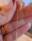 Video of designer holding a linear diamond pave mini hoop earrings | Camille Jewelry