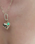 14K yellow gold puffy heart charm and emerald bezel set charm on a charm holder necklace by Camille Jewelry.