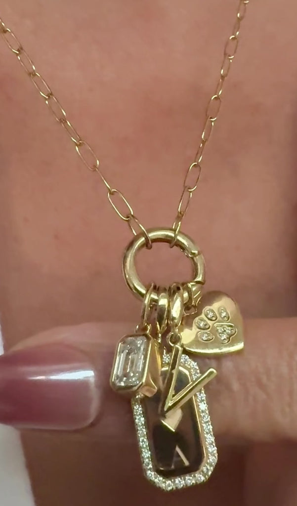 Diamond,personalized gold charms on models neckline by Camille Jewelry