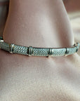Sterling silver pave cuff bracelet with stations on a pink cloth background - Camille Jewelry