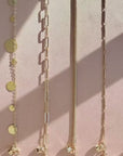 Convertible chain necklace worn five ways including choker, long layer, bracelet wrap, sunglass chain, and earbud holder by Camille Jewelry. 